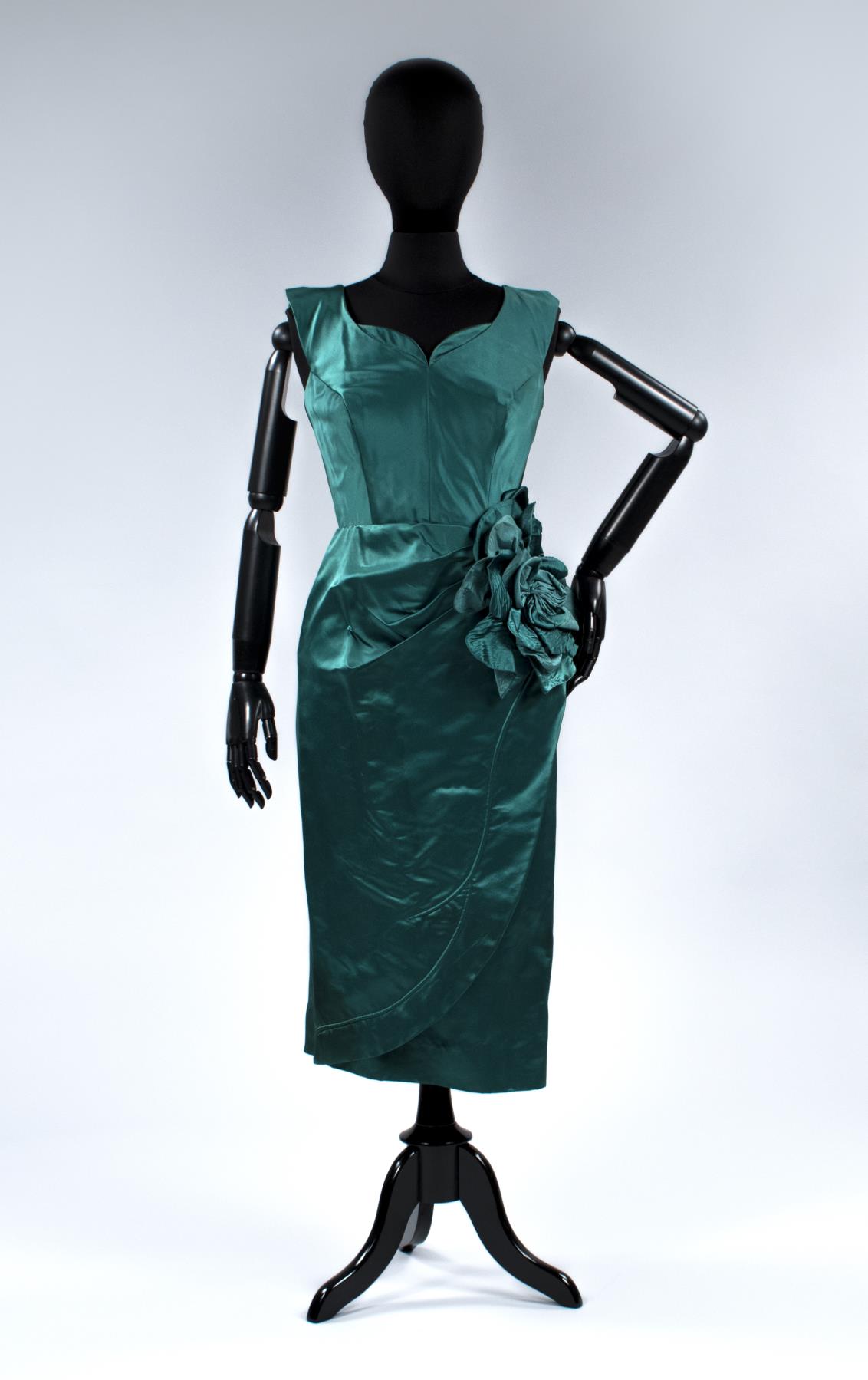Image of Emerald green cocktail dress with large flower on left hip, ca. 1950